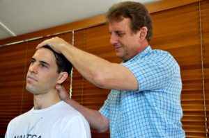 Chiropractor performing a professional spinal assessment at Ansell Chiropractic Centre in Townsville